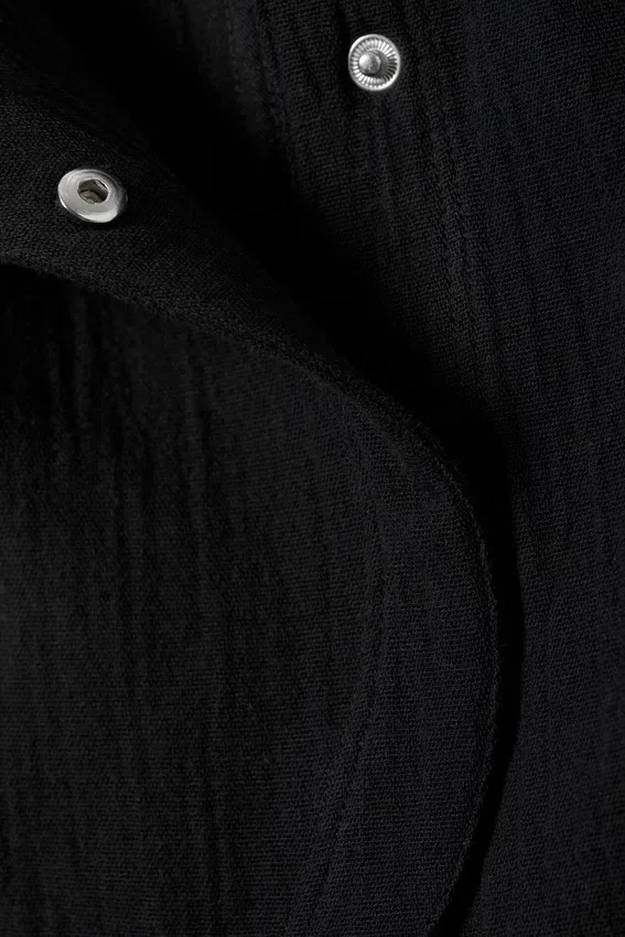 Ärmelloses, asymmetrisches Peplum-Oberteil – Schwarz Ärmelloses, asymmetrisches Peplum-Oberteil – Schwarz