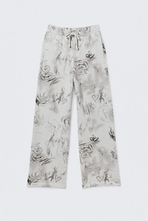 Weit geschnittene Jogginghose aus Baumwolle – Grau meliert – Scribble-Print Weit geschnittene Jogginghose aus Baumwolle – Grau meliert – Scribble-Print